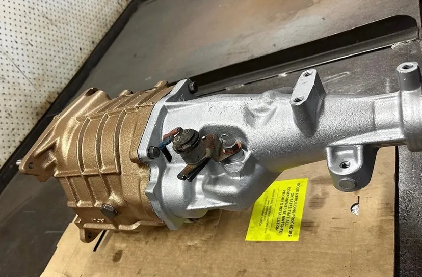 Rebuilt transfer case on the workbench with its fitting instructions attached